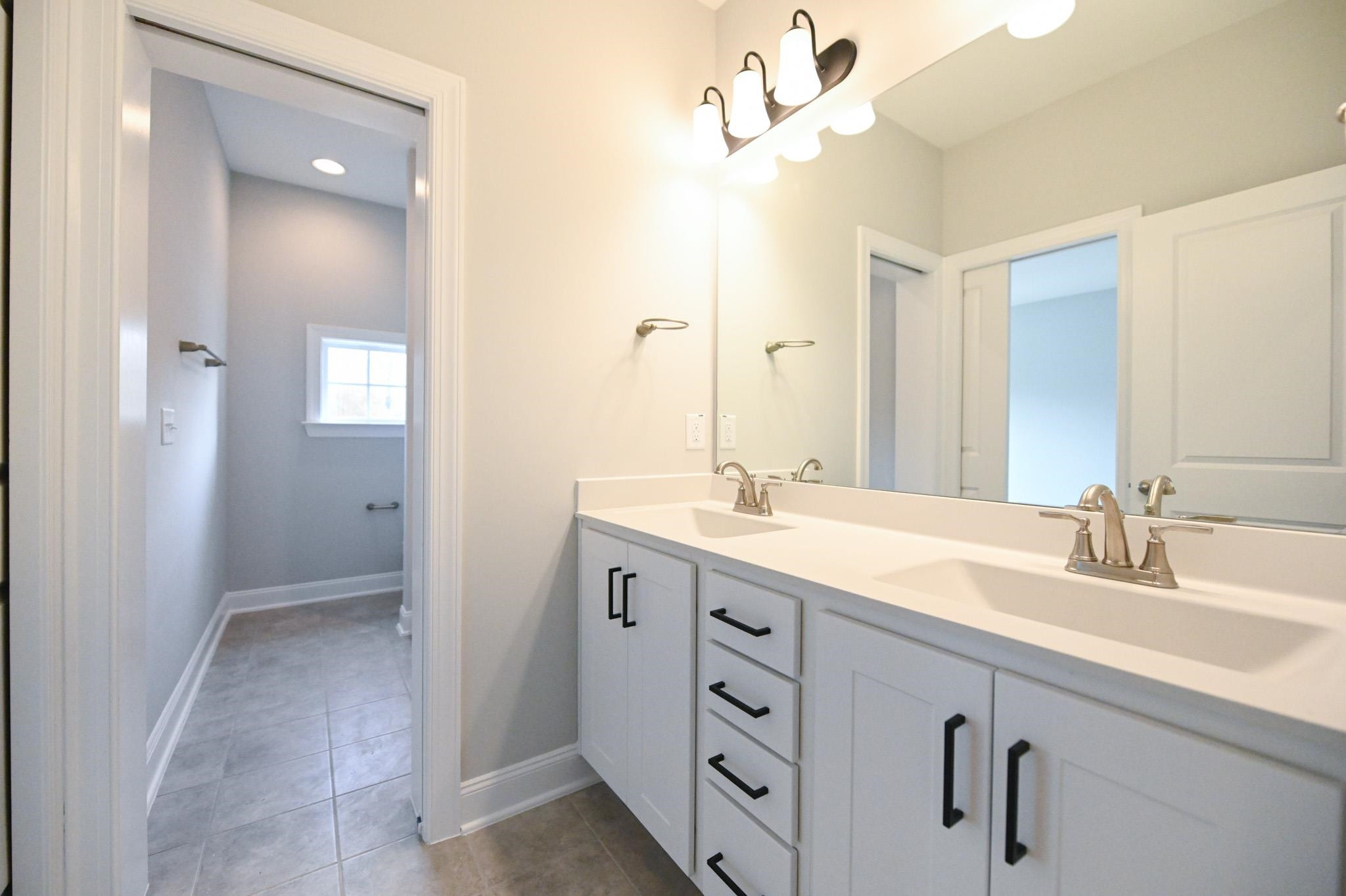 110 Freewill Place Raleigh, NC 27603 - Photo 30 of 39 a bathroom with a double vanity sink a mirror and a shower