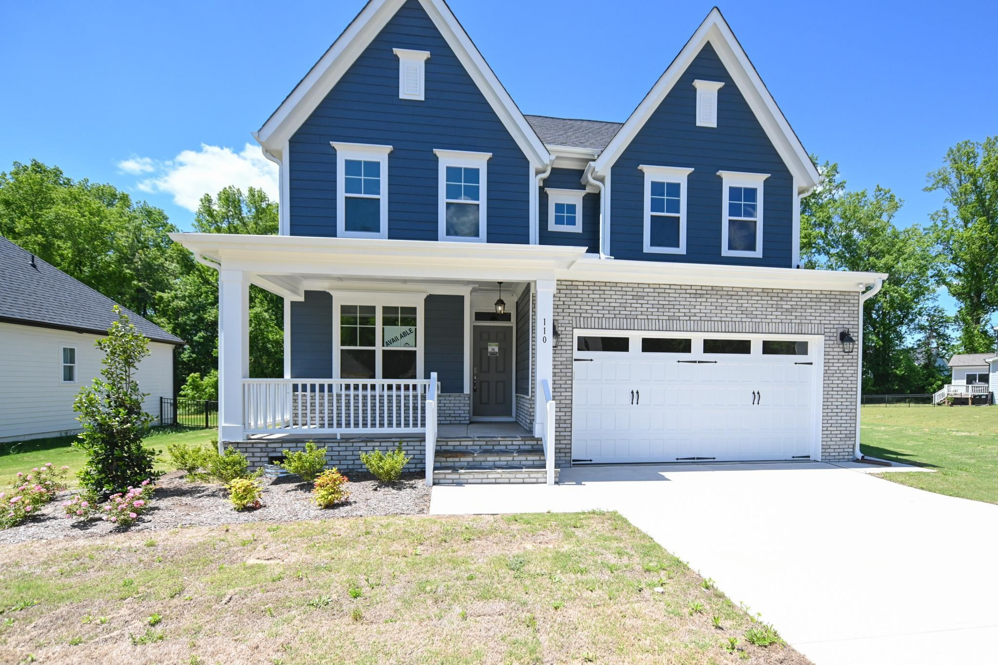 110 Freewill Place Raleigh, NC 27603 - Photo 3 of 39 a front view of a house with a yard and garage