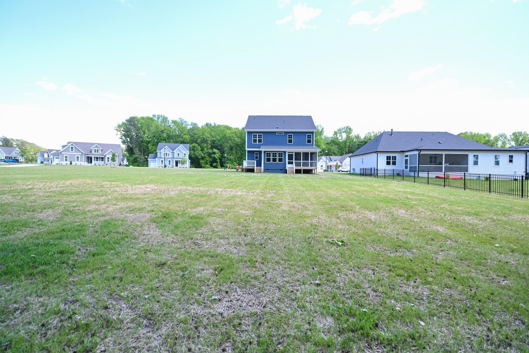 110 Freewill Place Raleigh, NC 27603 - Photo 39 of 39 a view of a house with a big yard and large trees