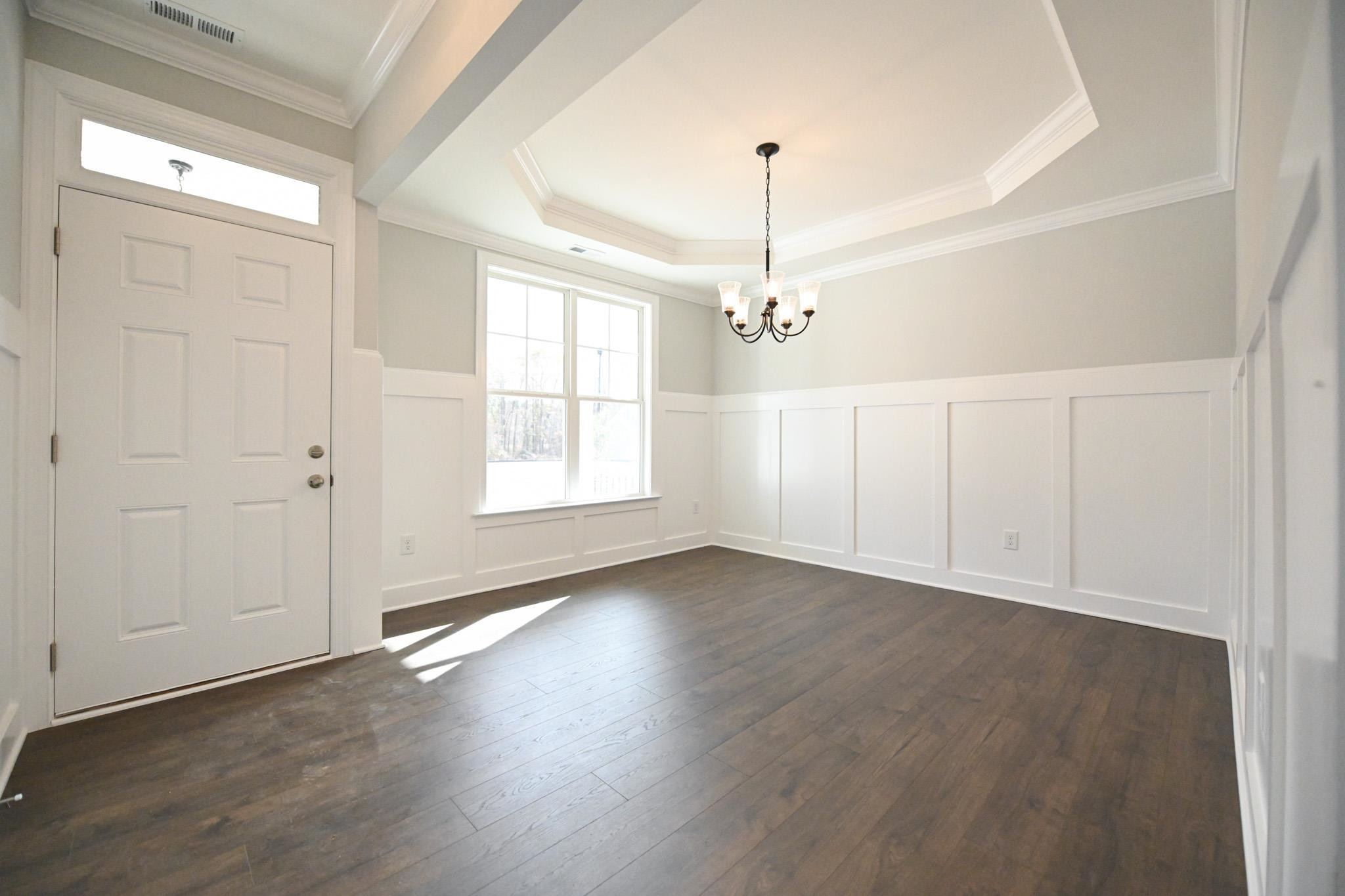 110 Freewill Place Raleigh, NC 27603 - Photo 4 of 39 an empty room with wooden floor closet and windows