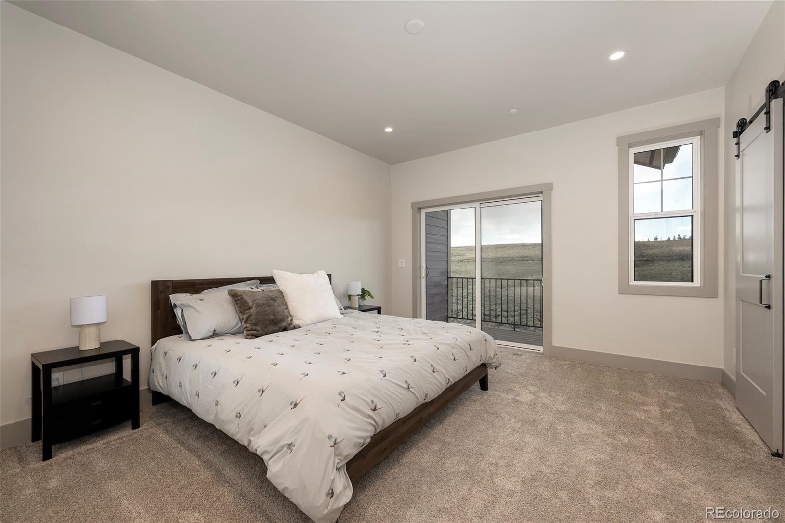 235 Eagle Ridge Circle Granby, CO 80446 - Photo 13 of 34 a bedroom with a bed and a window