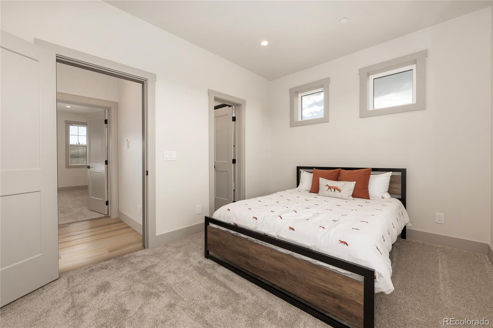 235 Eagle Ridge Circle Granby, CO 80446 - Photo 20 of 34 a spacious bedroom with a bed and a view of bathroom