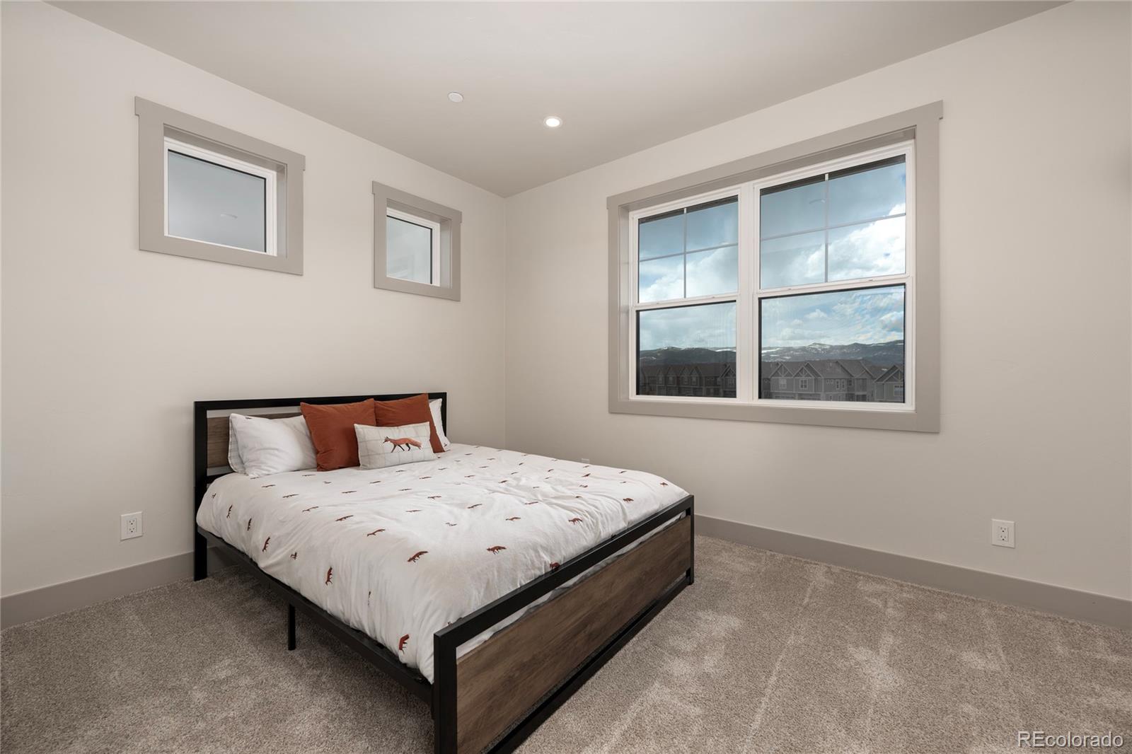 235 Eagle Ridge Circle Granby, CO 80446 - Photo 21 of 34 a large bed sitting in a bedroom next to a window