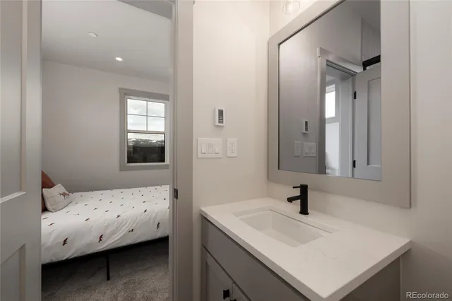 a en suite bathroom with a sink and a mirror