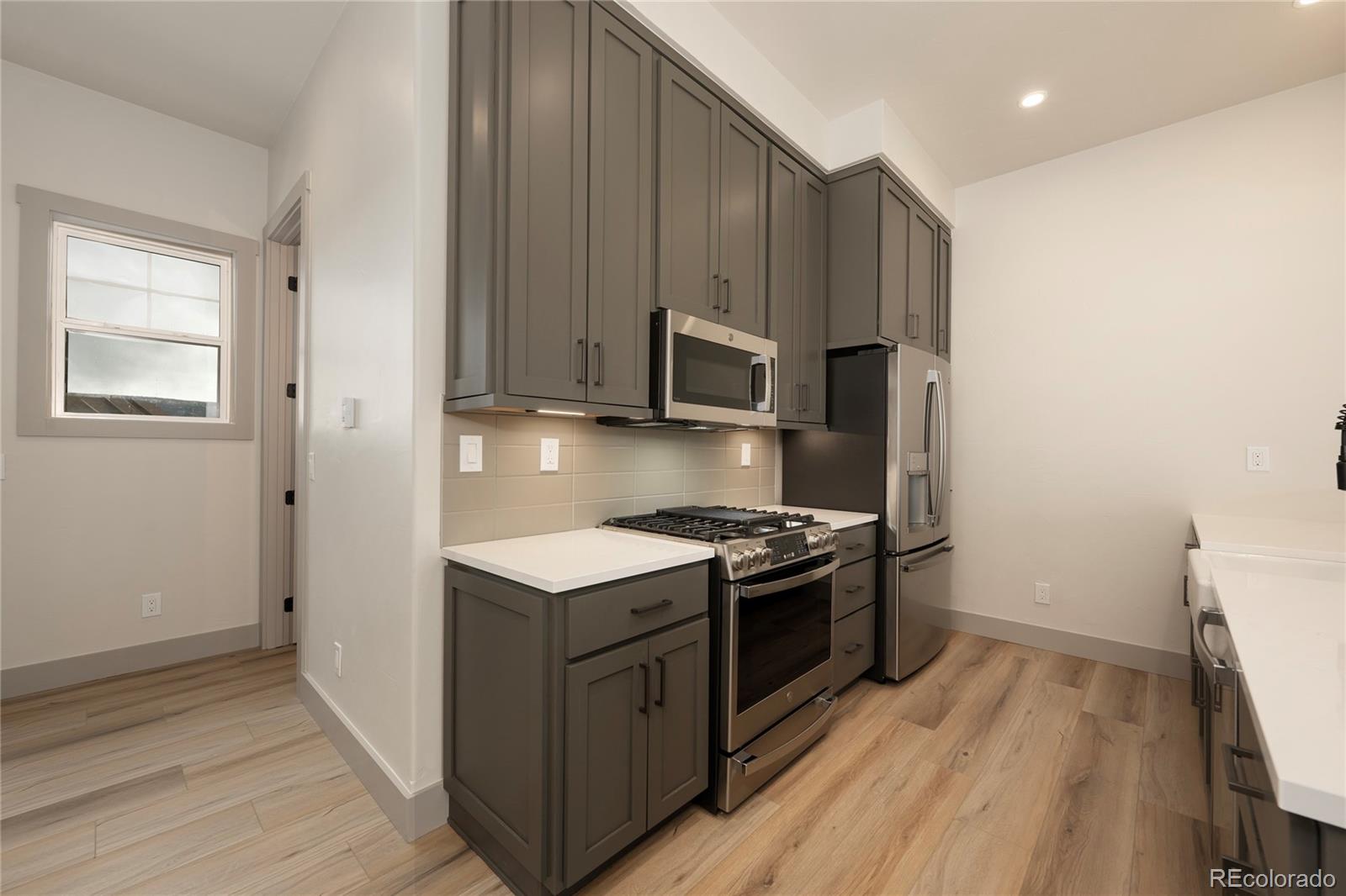 235 Eagle Ridge Circle Granby, CO 80446 - Photo 8 of 34 a kitchen with stainless steel appliances granite countertop a stove a sink and a refrigerator