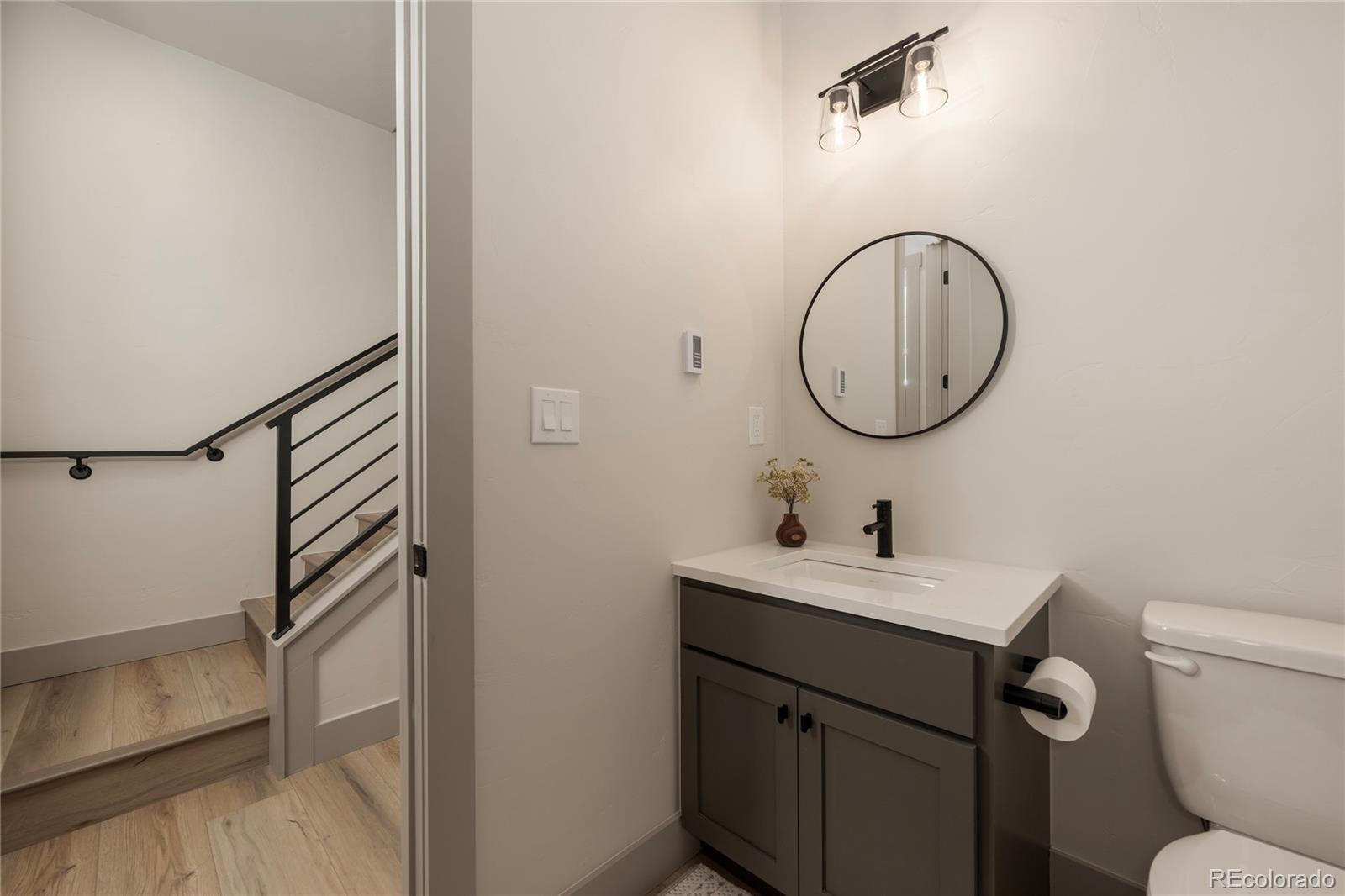 235 Eagle Ridge Circle Granby, CO 80446 - Photo 10 of 34 a bathroom with a sink toilet and a mirror