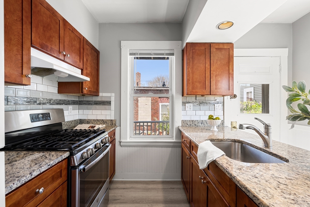 2 Thorndike Street, Unit 2 Arlington, MA 02474 - Photo 11 of 22 a kitchen with a sink stove top oven and cabinets