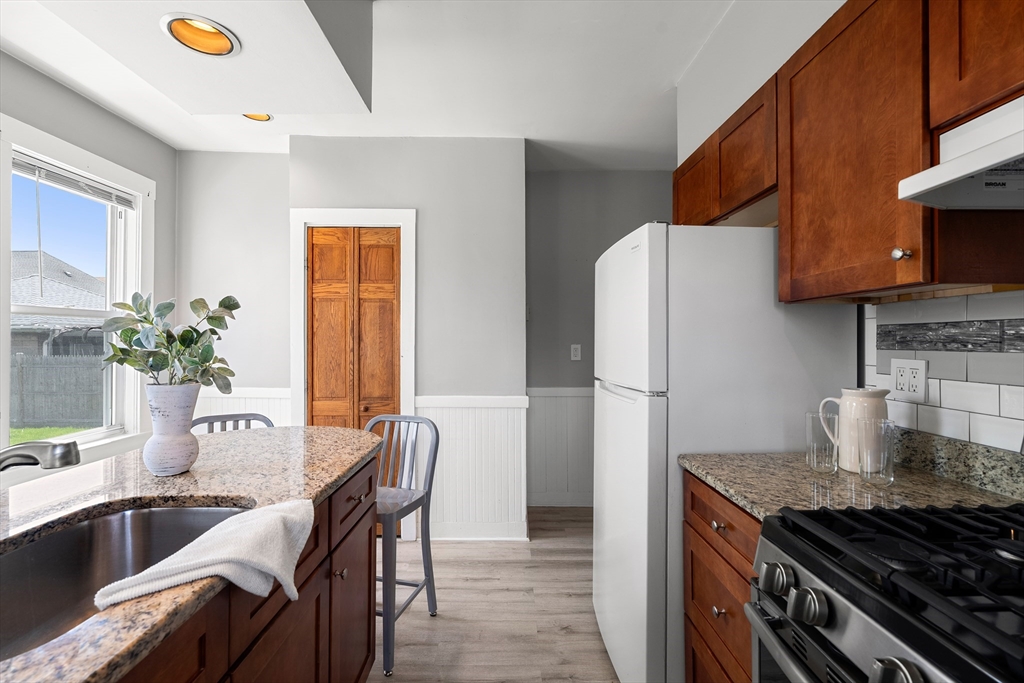 2 Thorndike Street, Unit 2 Arlington, MA 02474 - Photo 15 of 22 a kitchen with stainless steel appliances granite countertop a stove a refrigerator and a sink