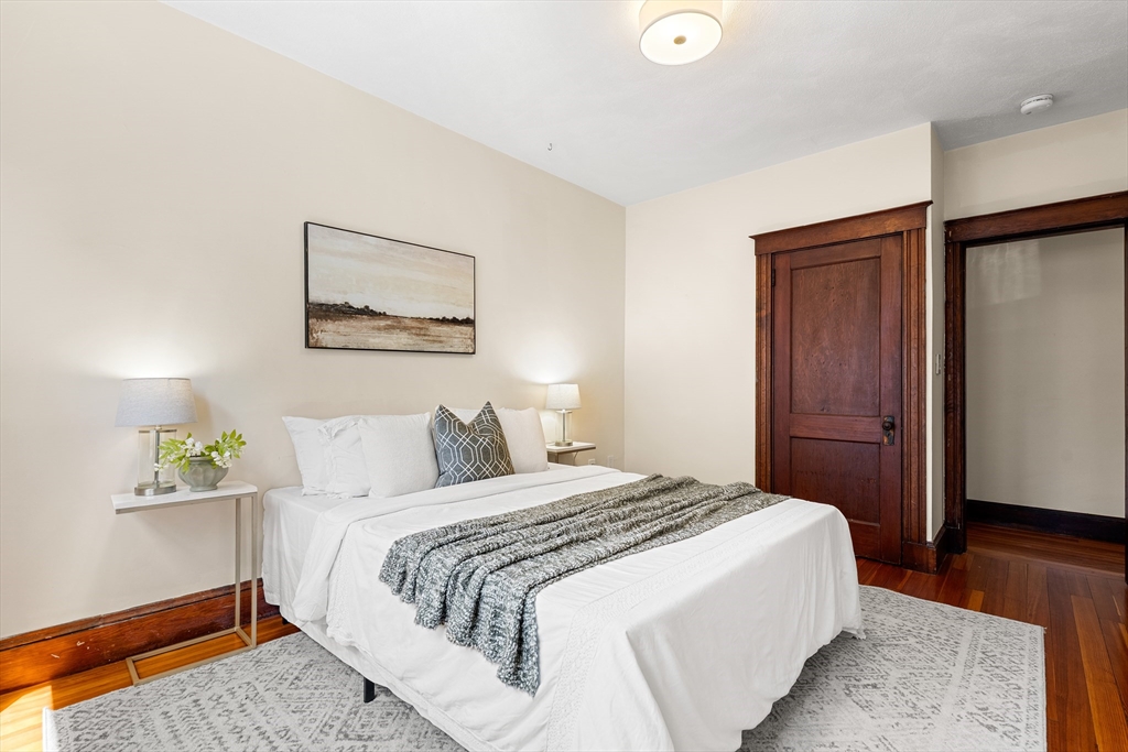 2 Thorndike Street, Unit 2 Arlington, MA 02474 - Photo 17 of 22 a bedroom with a bed and a painting on the wall
