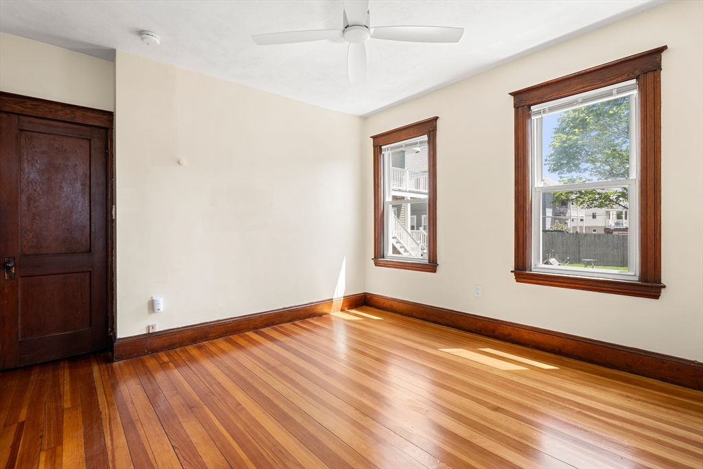 2 Thorndike Street, Unit 2 Arlington, MA 02474 - Photo 19 of 22 a view of an empty room with wooden floor and a window