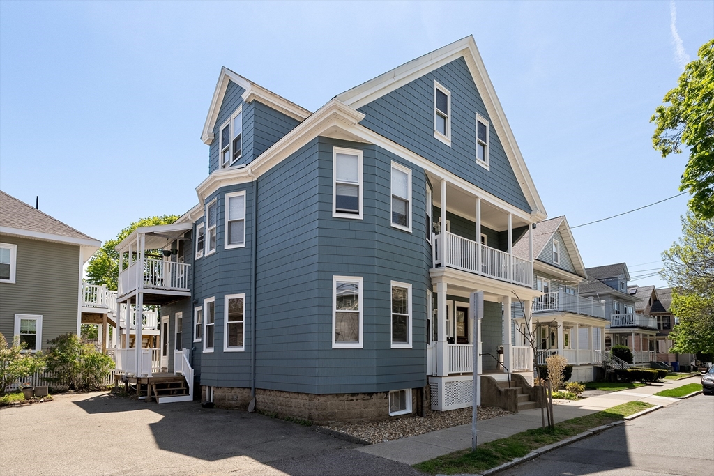 2 Thorndike Street, Unit 2 Arlington, MA 02474 - Photo 2 of 22 a front view of a house with a yard