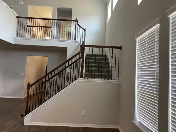 a kitchen with granite countertop a refrigerator and a stove top oven