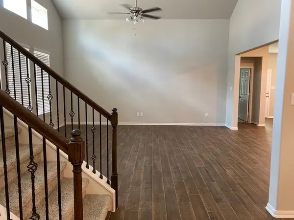 a view of staircase with wooden floor and a window