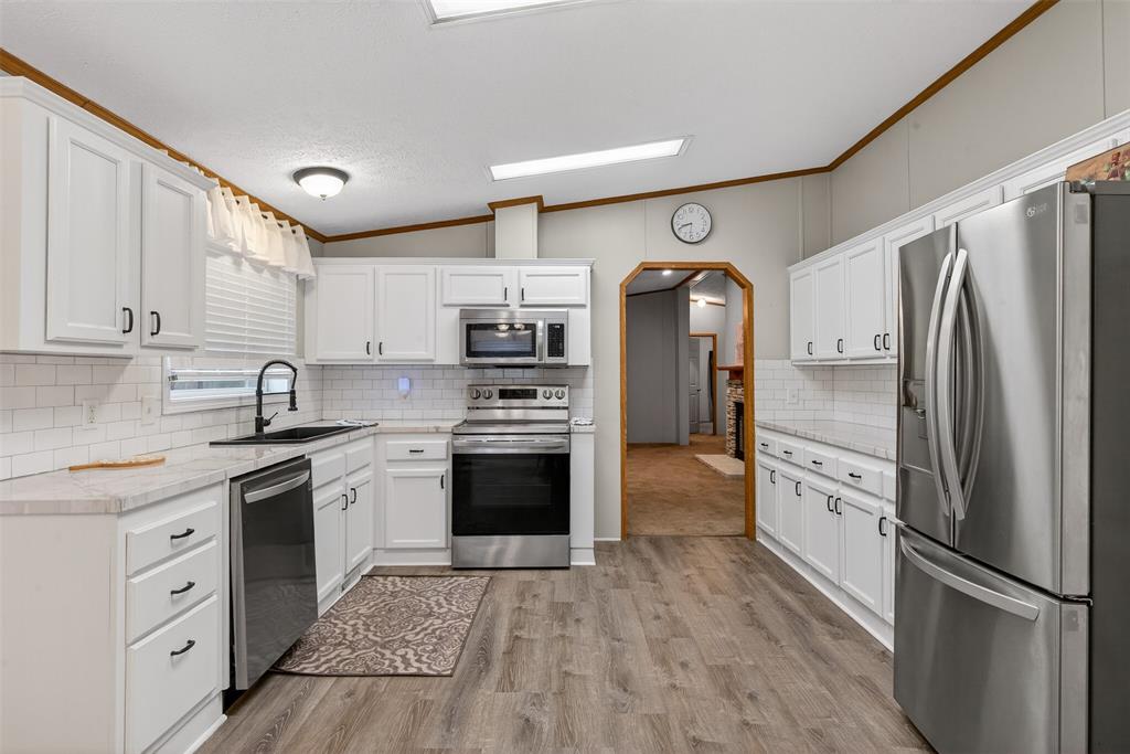 1202 Princeton Road Princeton, LA 71067 - Photo 11 of 32 a kitchen with stainless steel appliances granite countertop a refrigerator and a stove top oven