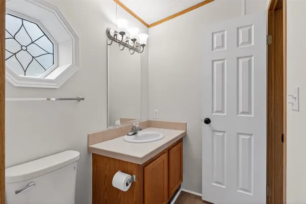 a view of an empty room with a chandelier fan