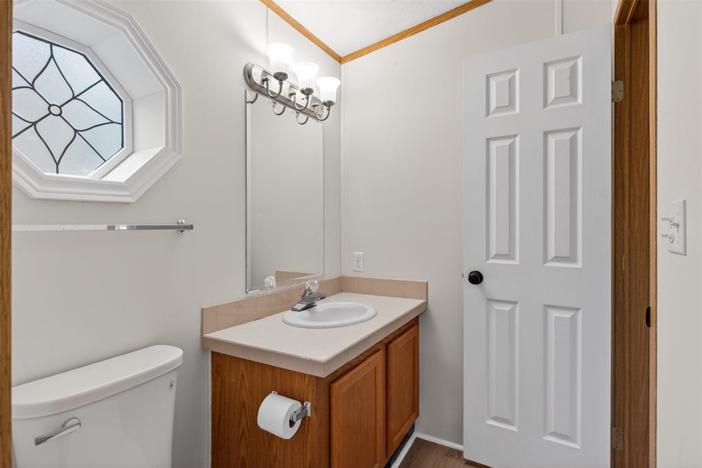1202 Princeton Road Princeton, LA 71067 - Photo 15 of 32 a bathroom with a sink a toilet and a mirror