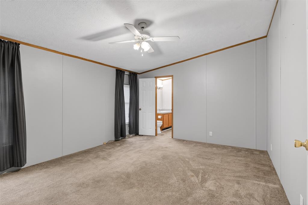 1202 Princeton Road Princeton, LA 71067 - Photo 17 of 32 a view of an empty room with a chandelier fan