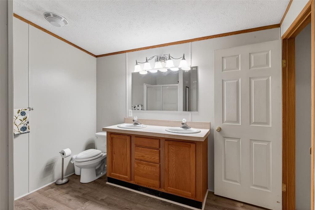 1202 Princeton Road Princeton, LA 71067 - Photo 21 of 32 a bathroom with a toilet sink and mirror