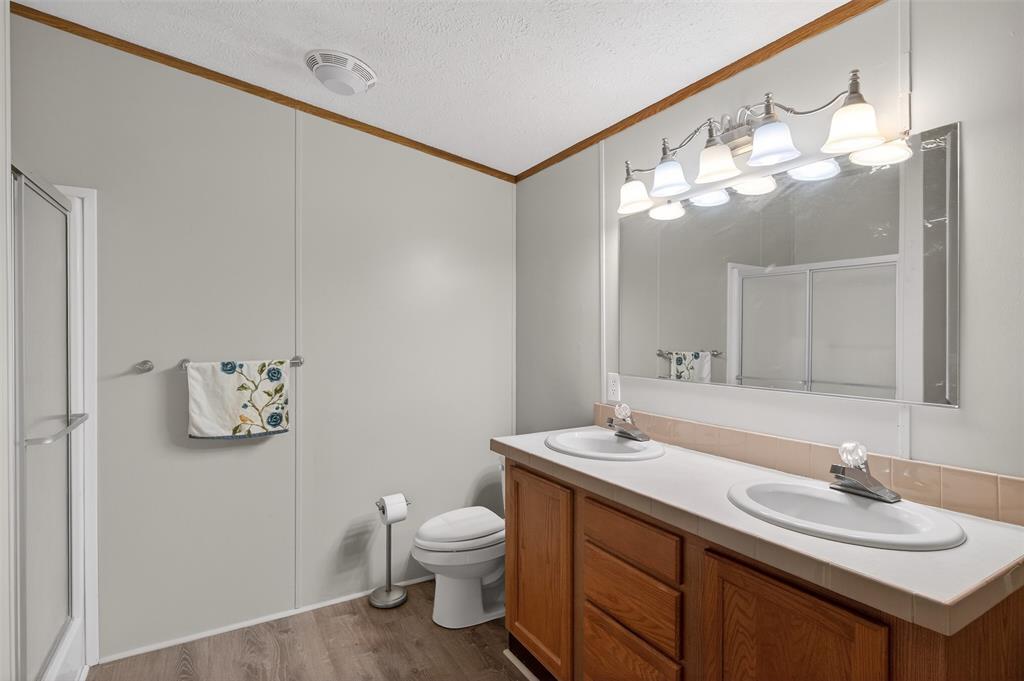1202 Princeton Road Princeton, LA 71067 - Photo 22 of 32 a bathroom with a sink a toilet and a mirror