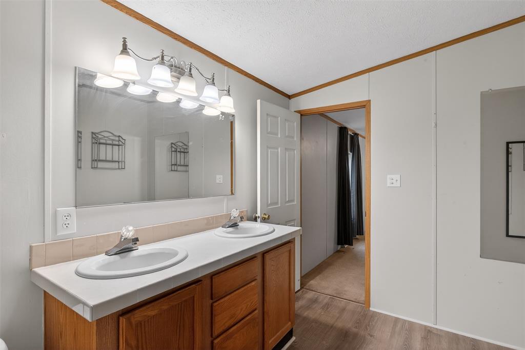 1202 Princeton Road Princeton, LA 71067 - Photo 23 of 32 a bathroom with a sink double vanity and a mirror
