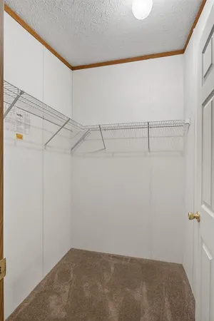 an empty room with a ceiling fan and a window