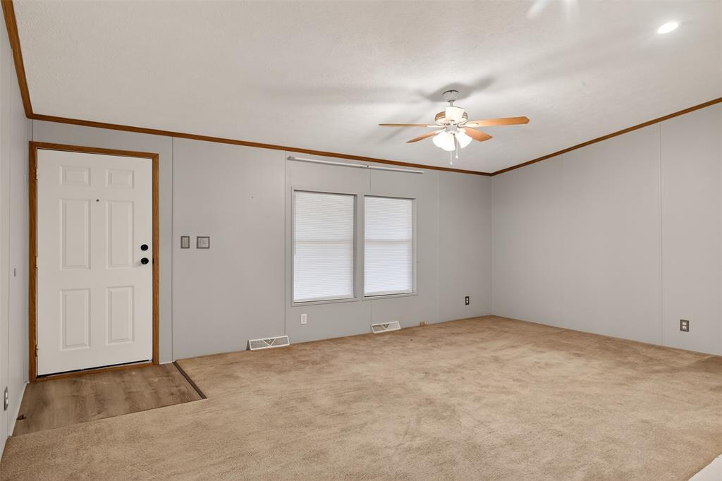 1202 Princeton Road Princeton, LA 71067 - Photo 4 of 32 an empty room with chandelier fan and windows