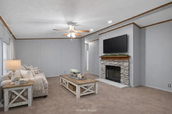 an empty room with fireplace fan and windows