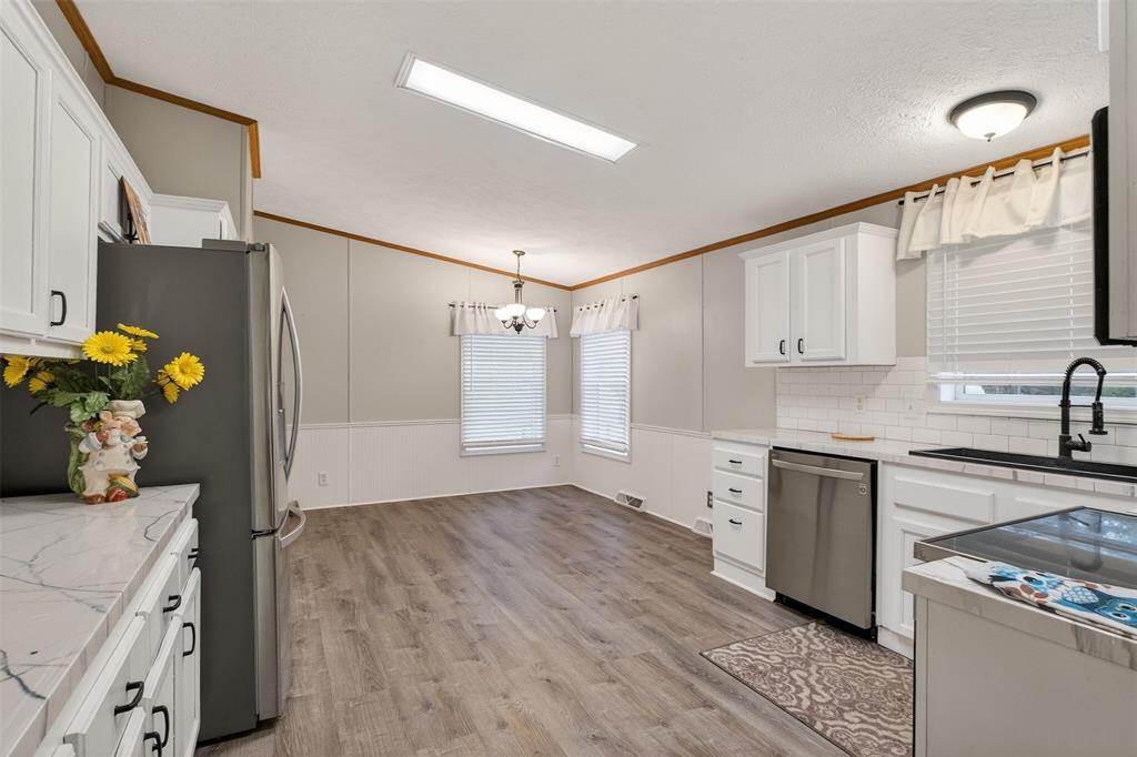 1202 Princeton Road Princeton, LA 71067 - Photo 9 of 32 a kitchen with a sink appliances and cabinets