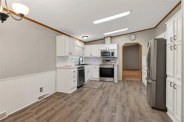 a kitchen with stainless steel appliances granite countertop a sink and a stove