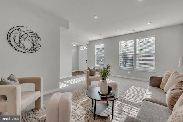 a living room with furniture a window and a table