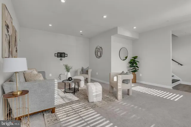 a living room with furniture a window and a potted plant