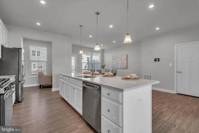 a kitchen with kitchen island a sink appliances and cabinets