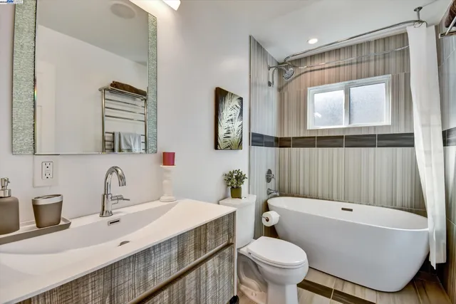 a bathroom with a sink a toilet and a mirror