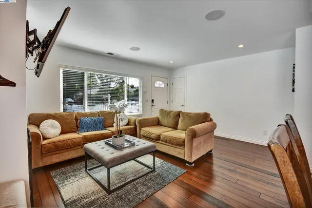 a living room with furniture and a floor to ceiling window