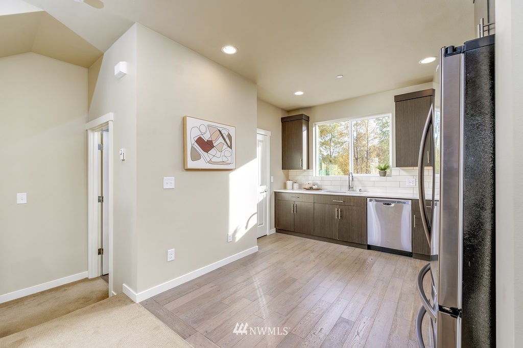 4227 Northeast 3rd Lane Renton, WA 98059 - Photo 4 of 40 a kitchen with a refrigerator and a sink