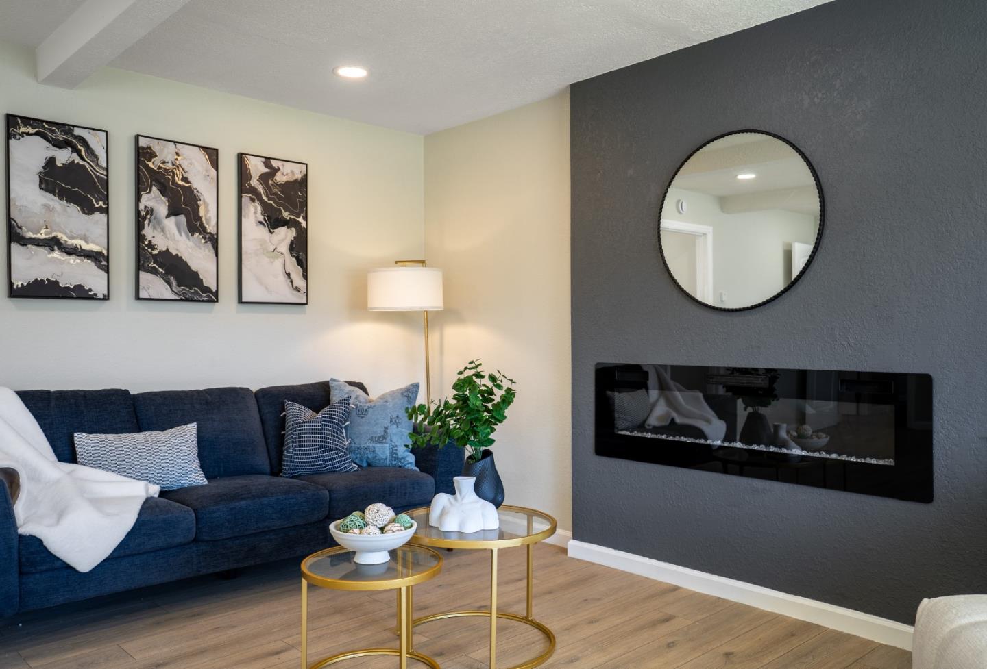 a living room with furniture and a painting