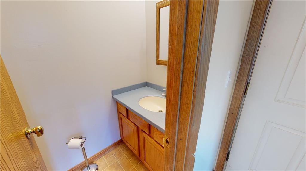 3902 Knoyle Road Erie, PA 16510 - Photo 11 of 25 a bathroom with a sink and mirror