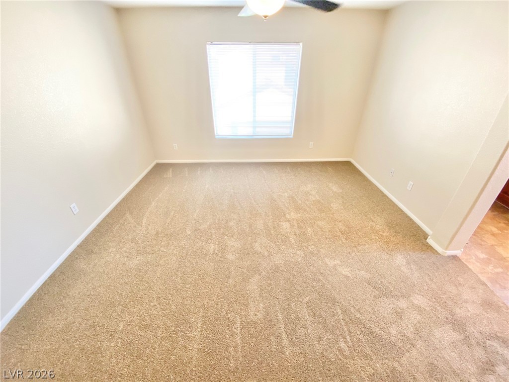 8569 Rhamus Court Las Vegas, NV 89149 - Photo 23 of 35 A well-lit room awaits with fresh carpeting and a window offering natural light.