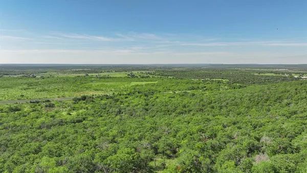 a view of a field with an ocean
