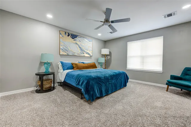 a bedroom with a large bed and a window