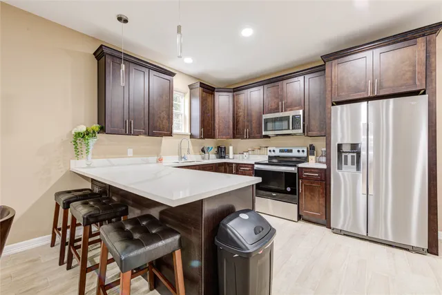 a kitchen with a refrigerator a stove a sink and a refrigerator