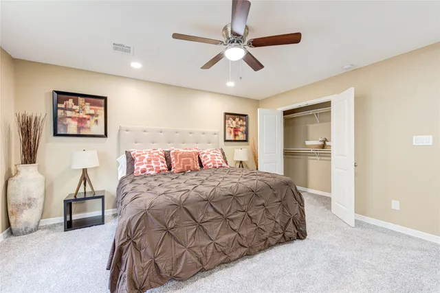 a bedroom with a large bed and a chandelier