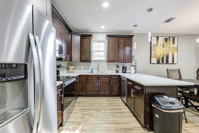 a kitchen with a sink stove and refrigerator