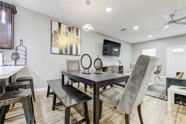 a view of a a dining room with furniture window and wooden floor