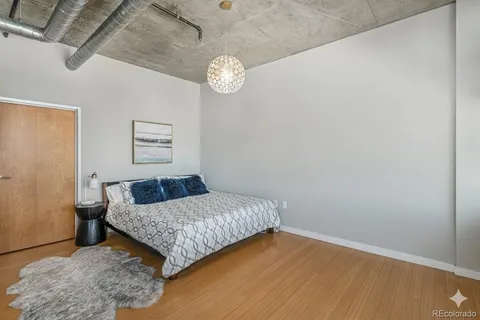 a bedroom with a bed and a table in it