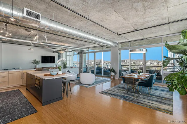 a view of a kitchen with kitchen island a stove and a living room view
