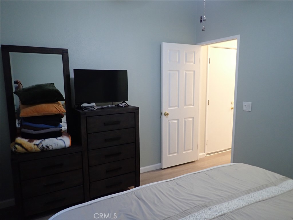 27250 Murrieta Road, Unit 386 Menifee, CA 92586 - Photo 17 of 32 a bedroom with a bed and a television