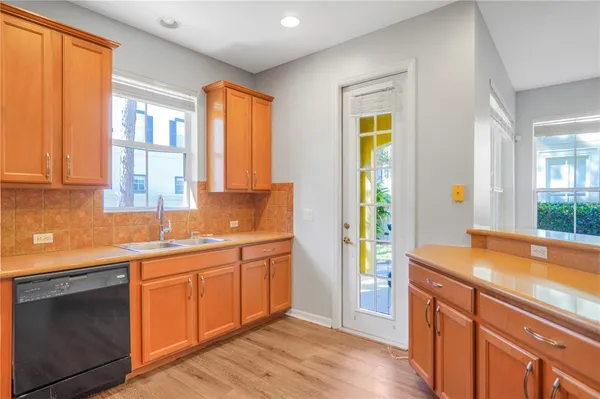 a room with stainless steel appliances granite countertop a granite counter tops and a window