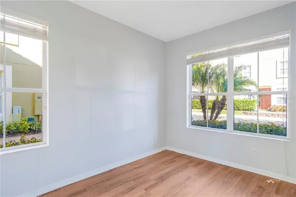 a view of an empty room with wooden floor