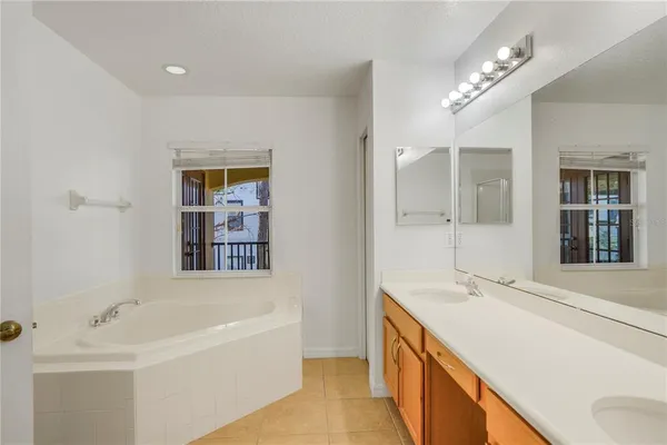 an empty room with a ceiling fan and closet area